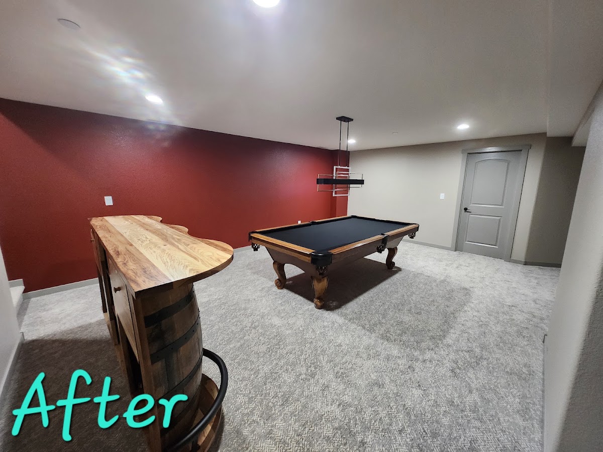 Finished basement with bar, red accent wall and pool table