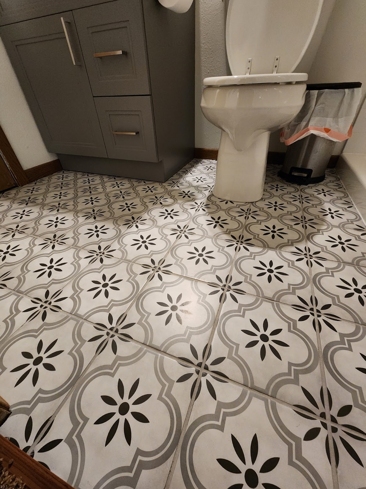 Finished bathroom with patterned tile floor and vanity